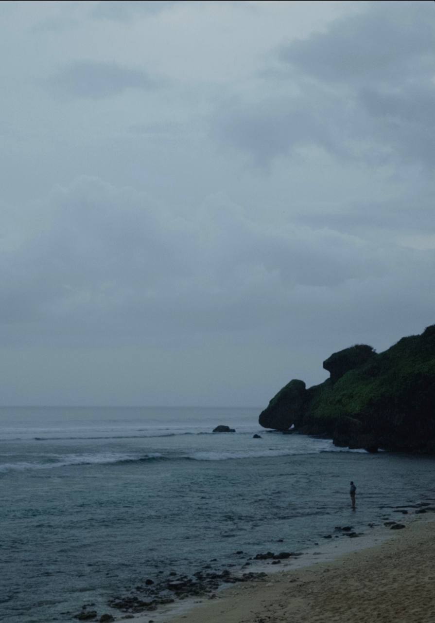 Moody overcast coastline, cliff and sea under a grey sky